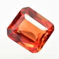 Natural gemstone orange Padparadscha sapphire on gray background