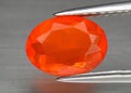 Natural gemstone orange fire opal on gray background Royalty Free Stock Photo