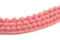 Natural gemstone pink coral beads on a white background Royalty Free Stock Photo