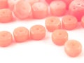 Natural gemstone pink coral beads on a white background Royalty Free Stock Photo