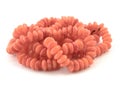 Natural gemstone pink coral beads on a white background Royalty Free Stock Photo