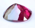 Natural gemstone red rhodolite garnet on gray background