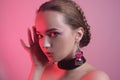 Natural girl in accessories. Girl with a beautiful professional braid hairstyle. Girl on a pink background with beautiful daily pi