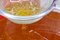 Golden Raw Honey Flowing Through Sieve Close-up Royalty Free Stock Photo