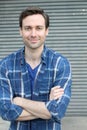 Natural good looking young man smiling with arms crossed Royalty Free Stock Photo