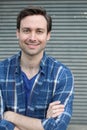 Natural good looking young man smiling with arms crossed Royalty Free Stock Photo