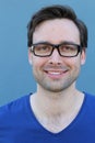 Natural good looking young man smiling over blue background Royalty Free Stock Photo
