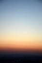Natural gradient of colors after sunset and a young moon in the sky Royalty Free Stock Photo