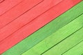 Natural grain textured wood boards are painted green and red and arranged diagonally. Royalty Free Stock Photo