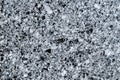 Natural granite stone surface with speckled gray and black patterns, strong texture, ideal for product presentation Royalty Free Stock Photo