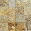 Natural granite tiles in warm earth tones arranged in a grid pattern for flooring or countertops Royalty Free Stock Photo