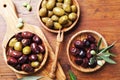 Natural greek olives in bowls with kitchen board from olive tree from above. Royalty Free Stock Photo