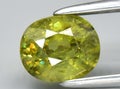 natural green demantoid garnet gem on the background