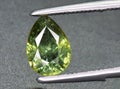 natural green demantoid garnet gem on the background