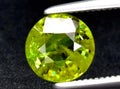 natural green demantoid garnet gem on the background