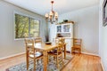 Natural grey dining room with wood table and cabinet.