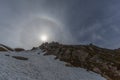 Natural halo with sun in blue sky and snowy mountains Royalty Free Stock Photo