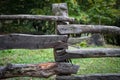 Natural hand made fence made of wooden tree brenches. Close up view of village fence with moss on wooden surface