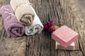 Natural hand made soap with dry pink roses on vintage wooden board. Spa