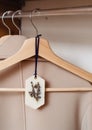 Natural handmade scented soy wax lavender sachet hanging on clothes hanger on rack in wardrobe.