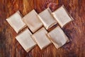 Natural handmade soap bars on wooden background. Spa organic soap in eco paper packaging Royalty Free Stock Photo