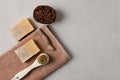 Natural handmade soap, natural bristle brush, peeling stone on beige towel and pastel background, selective focus, copy space, top