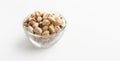 Natural healthy beer snack. Pistachios in glass bowl on white background