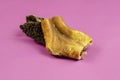 Natural healthy treats for dogs of premium quality. Dried beef stomach, buffalo tripe on a pink background