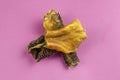 Natural healthy treats for dogs of premium quality. Dried beef stomach, buffalo tripe on a pink background