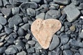 Natural Heart Shaped Sea Stone on Rocks Royalty Free Stock Photo