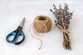 Natural hemp cord ball, scissors and dry lavender bouquet on a rough white surface. Roll of jute string or flax twine. Coarse Royalty Free Stock Photo