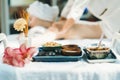 Natural herbal ingredient in front of woman having body massage. Tranquility. Royalty Free Stock Photo