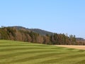 natural hilly landscape with blue sky in spring, farm lands cultivated in rural area in germany