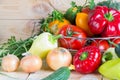 Natural homegrown food concept. Assorted fresh vegetables from new harvest collected in a wicker basket on wooden Royalty Free Stock Photo