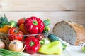 Natural homegrown and homemade food concept. Fresh vegetables and half of bread on wooden table. Royalty Free Stock Photo