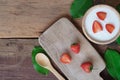 Natural homemade plain organic yogurt mixed with fresh berry fruit in wood bowl and wood spoon on wood table background Royalty Free Stock Photo