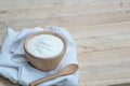 Natural homemade plain organic yogurt in wooden bowl and wood spoon on wood texture background Royalty Free Stock Photo