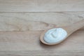 Natural homemade plain organic yogurt in wooden wood spoon on wood texture background Royalty Free Stock Photo