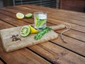 Natural homemade repellents on wooden table. Lime and lemon with cloves