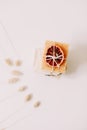 Natural homemade soap bars with orange slices and flowers on white background. Spa concept, body care products. top view. Royalty Free Stock Photo