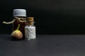 Natural Homeopathic medicine concept - Homeopathic medicine bottles with wild fruit on dark background