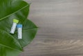 Natural Homeopathy concept - A homeopathy concept with homeopathic medicine bottles on green leaf with wood background. Medicine Royalty Free Stock Photo