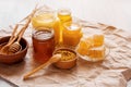 Natural honey in glass jars, honeycomb and pollen on Kraft paper background Royalty Free Stock Photo