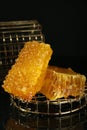 Natural honeycombs with tasty honey on black background