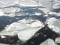 Natural white ice blocks breaking up against shore and sea ice during freezing spring weather