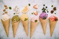 Icecreams with fruit and nut ingredients - colorful ice cream with cones on a white background