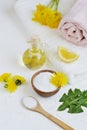 Natural ingredients for homemade body salt scrub with dandelion flowers, lemon, honey and olive oil Royalty Free Stock Photo