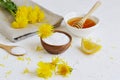 Natural ingredients for homemade body salt scrub with dandelion flowers, lemon, honey and olive oil Royalty Free Stock Photo