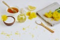 Natural ingredients for homemade body salt scrub with dandelion flowers, lemon, honey and olive oil Royalty Free Stock Photo