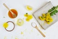 Natural ingredients for homemade body salt scrub with dandelion flowers, lemon, honey and olive oil Royalty Free Stock Photo